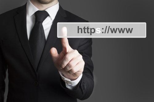 suited man pointing at a url